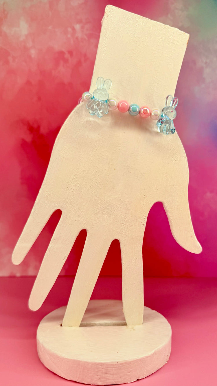 Blue and pink beaded bracelet with translucent bunny charms on display