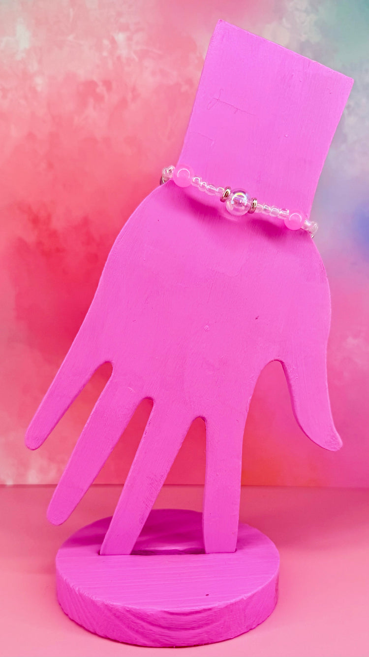 Minimal bracelet with center iridescent bead and pink accents