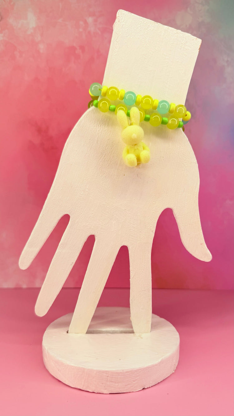 Green and yellow bracelet stack with plush bunny charm