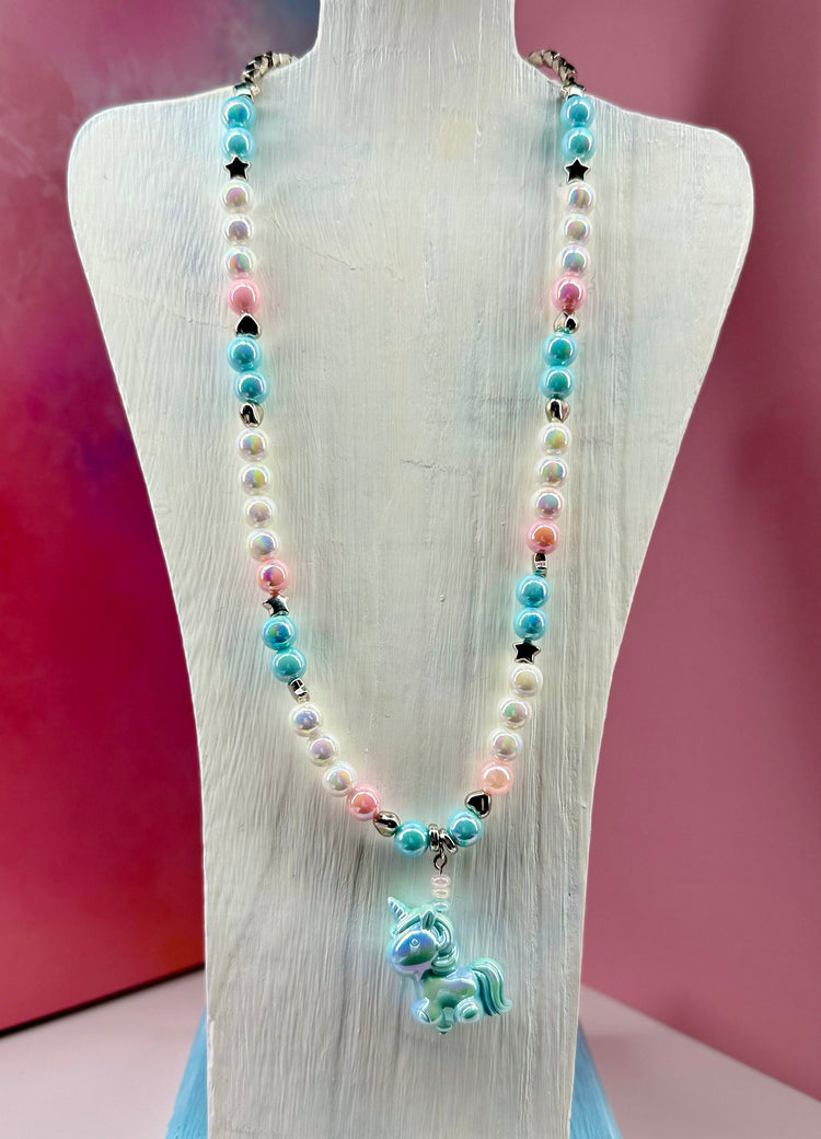Pastel beaded necklace with unicorn charm on a white bust display